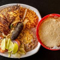 Mojarra Frita · Fried tilapia served with rice and beans.