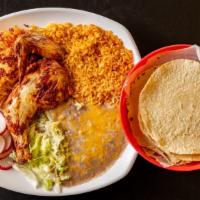 Pollo Asado · Grilled half chicken served with rice and beans.