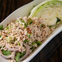 Larb · Red onions, green onions, cilantro, chili, lime juice, and crushed toasted rice with your ch...