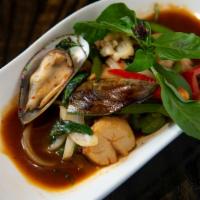 Pad Talay · Salmon, prawns, scallops, imitation crab meat, green mussels, and calamari are stir fried wi...