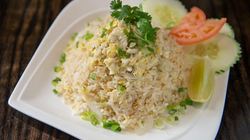 Crab Fried Rice · Thai fried rice dish includes stir-fried jasmine rice with egg, onions and succulent crab meat.