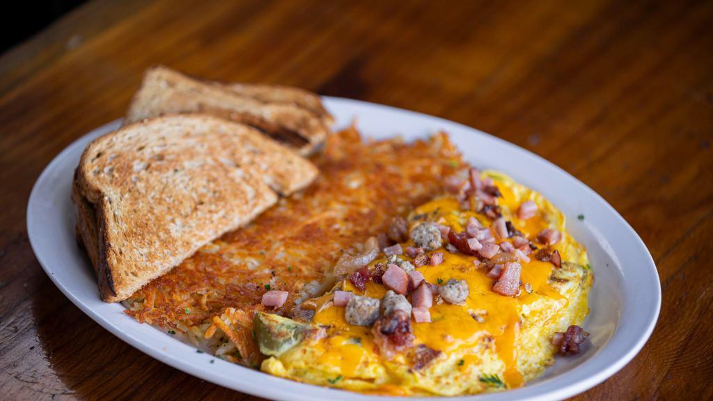 Gator Omelette · Stuffed with bacon, sausage, ham, peppers, onions & cheese.