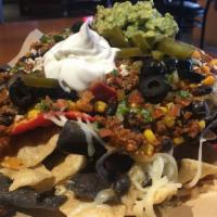 Deluxe Nachos
 · Choice of ground beef, pulled pork or shredded chicken. Topped
with pico de gallo, jalapenos...