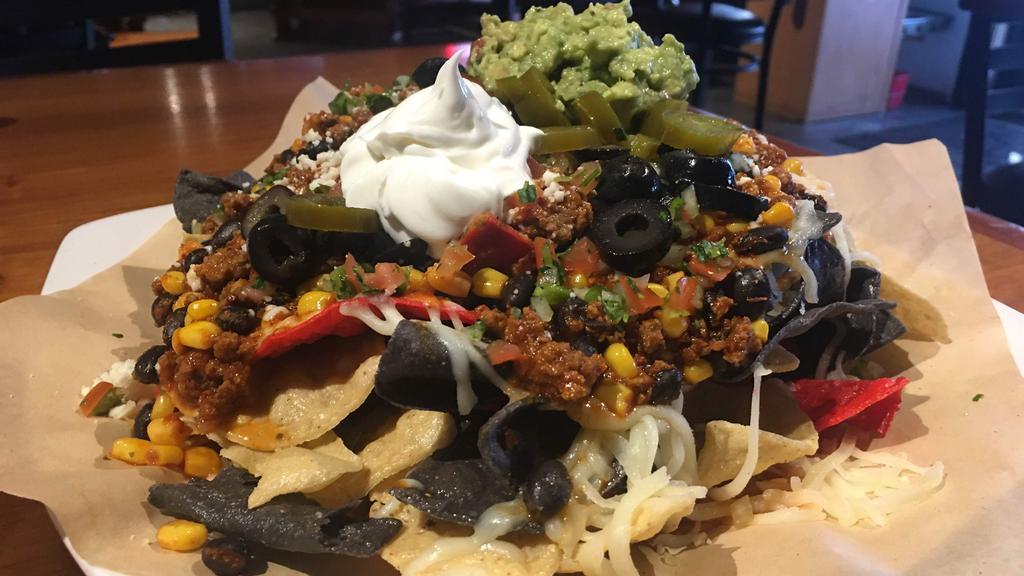 Deluxe Nachos
 · Choice of ground beef, pulled pork or shredded chicken. Topped
with pico de gallo, jalapenos, corn, black beans, queso fresco, sour
cream & guacamole.