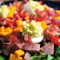 American Chopped Salad · Fresh greens topped with lean ham, smoked turkey, Swiss and tillamook sharp cheddar cheese, ...
