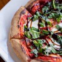 Capresse Pizza · Topped with fresh mozzarella cheese, tomatoes, basil & drizzle with
balsamic glaze .