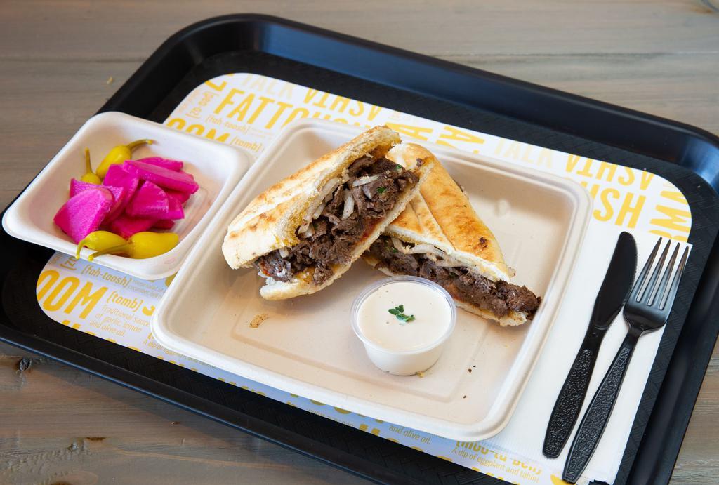 Shawerma Panini Sandwich · Flame-broiled, marinated beef, roasted tomato, tahini and piaz in a pressed French roll.