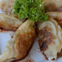 Chicken Pot Stickers · Chicken and vegetable dumplings, topped with vinegar soy sauce and sesame seeds.