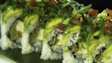 Green Sea Monster Roll · Tempura tofu, green onion topped with avocado, tomato, and seaweed salad.