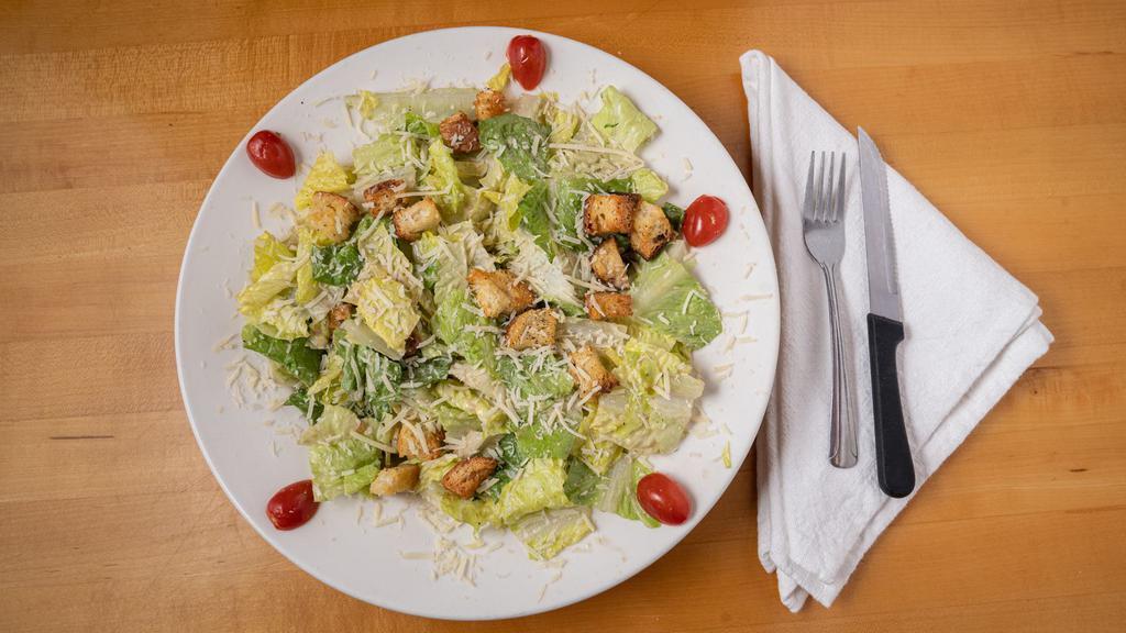 Our 25-Year Best Selling Caesar Salad · Classic Caesar dressing that is very garlicky! Salad is made with fresh romaine lettuce tossed with pub-made croutons and topped with parmesan cheese.