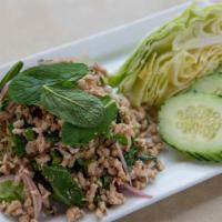 Larb Gai (Gf) · Gluten-free. Minced chicken tossed in fresh lime juice, onions, chili paste, mint leaves, ci...