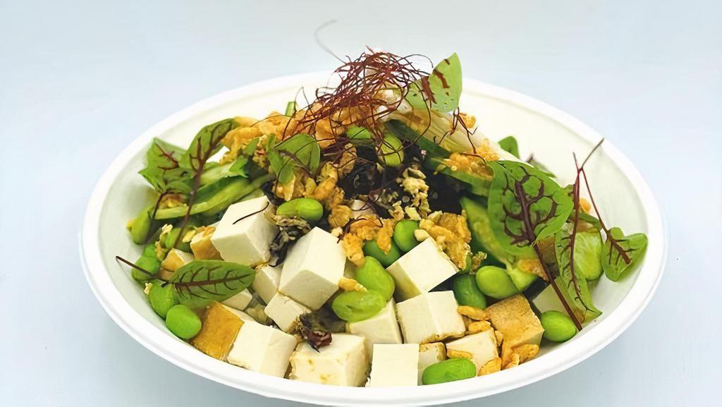 Sweet Ginger Tofu · Organic Tofu tossed in sweet soy served with edamame, hijiki salad, lotus roots, cucumbers, enoki ,mushrooms, green onions and topped with crispy garlic, chili oil crispy and chili threads