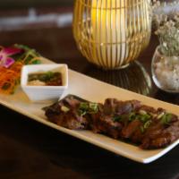 Neau Yang · BBQ sliced beef served with hot ground roasted rice sauce.