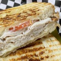 Cajun Turkey Panini · Cajun turkey breast, bacon and Pepper Jack cheese with mayo. Served on sourdough bread with ...