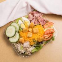 Chef Salad · Lettuce with mixed greens, turkey, ham, egg, tomato, cucumber and Cheddar. Garnished with to...