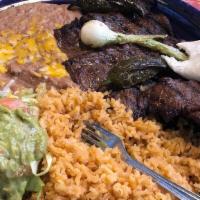 Carne Asada · Pieces of skirt steak cooked over charcoal. Served with guacamole, pico de gallo sauce, rice...