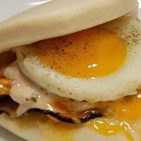 Ham Cheese Breakfast Bao · Grilled black forest ham, cheddar cheese, fried egg, ground black pepper, and house Pale Ely...