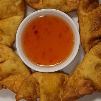 Golden Creamy Crab Wontons · 6 deep-fried handmade wontons filled with cream cheese and crab meat. Served with house swee...