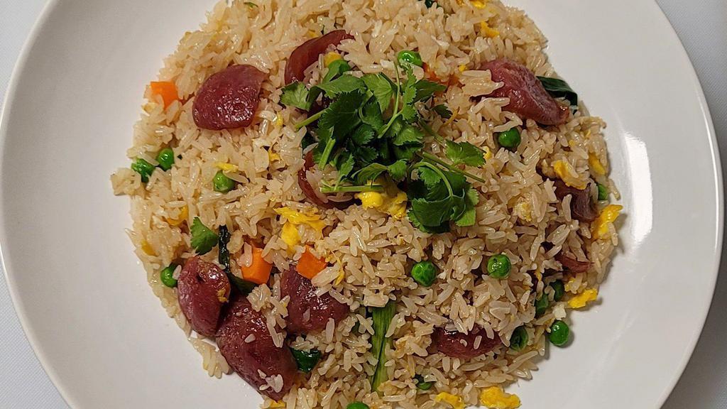 Chinese Sausage Fried Rice · Savory fried white rice with sweet and smoky pork Lap Cheong (Chinese sausages), eggs, peas, carrots, onions, and scallions.