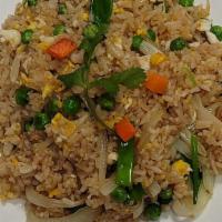 Simply Fried Rice · Simple savory stir-fried white rice with eggs, peas, carrots, onions, and scallions, topped ...