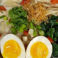 Hearty Chicken Noodle Soup · Thin rice noodles in savory chicken broth with chicken dumplings, soft boiled egg, spinach, ...