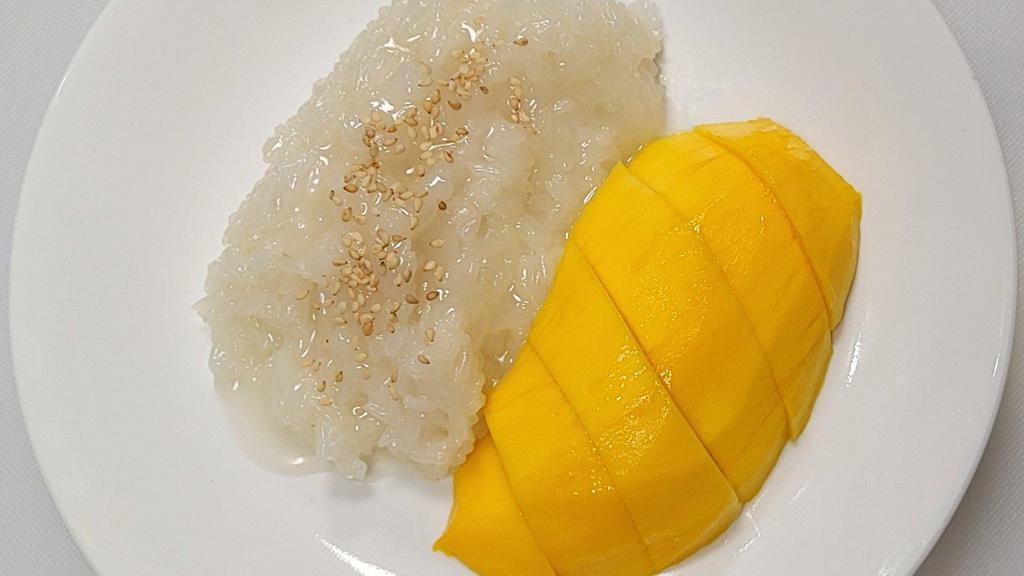 Mango Sticky Rice · Sliced ripe mango, served with lightly sweetened creamy coconut sticky rice topped with sesame seeds.