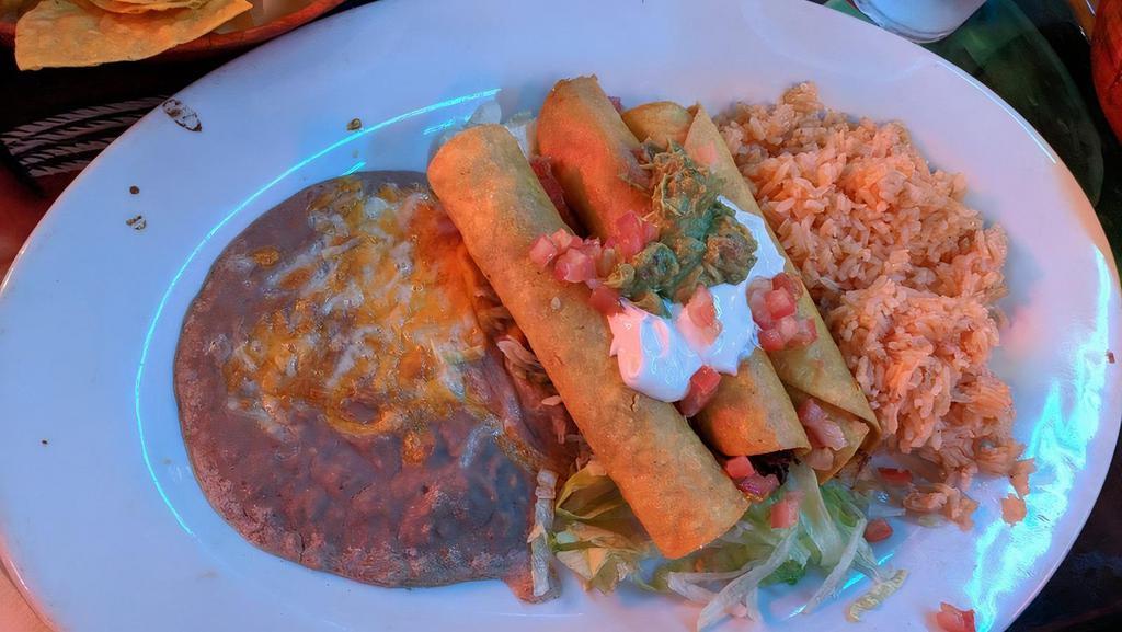 #17 Three Beef Taquitos · Deep fried corn tortillas roll stuffed with seasoned meat) served rice and beans guacamole and sour cream.