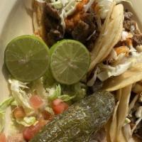 Tacos De Carne Asada · Three soft shell tacos with seasoned chunks of beef steak, served with onions, green peppers...