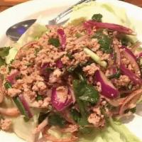 Larb Gai · Ground Chicken Mixed With Onions, Mint  Leaves, And Fresh Ground Rice In Spicy Lime Juice.
