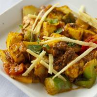 Paneer Karahi · Cubes of homemade Indian cheese cooked in a wok with onions, green peppers, fresh tomatoes, ...