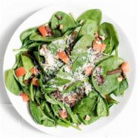 Spinach Salad Balsamico · Roasted balsamic onions, fresh tomato, parmesan, hazelnuts, and balsamic-red wine vinaigrette.