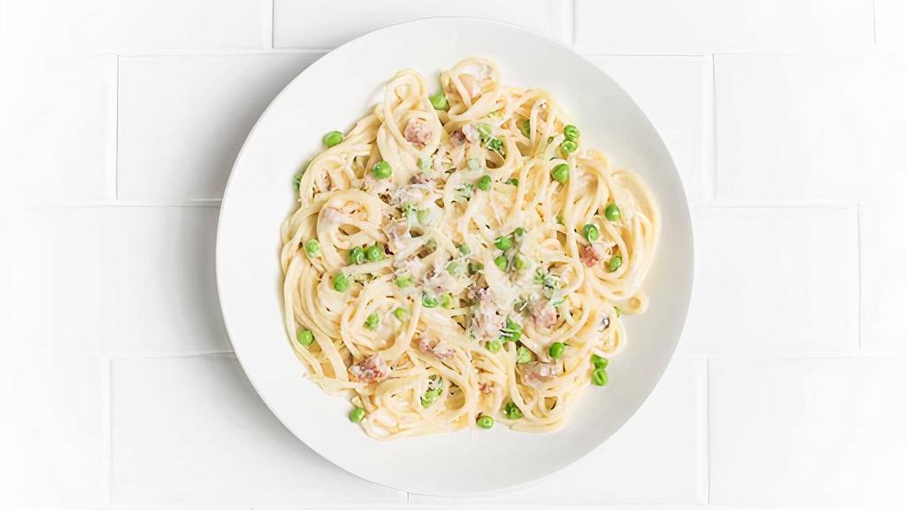 Spaghetti Carbonara · Creamy parmesan sauce, bacon, sweet peas, and cracked black pepper.