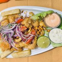 Jalea Peruana · A Peruvian party dish: lightly fried fish fillets, shrimp, and shellfish with a light lime d...