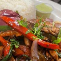 Lomo Saltado · Tender loin strips sautéed with fresh onions, tomatoes, bell peppers. Served with nice and F...