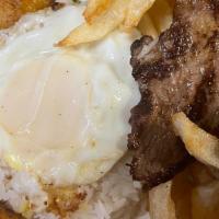 Bistek A Lo Pobre · Grilled sirloin steak (7oz.) topped with a fried egg, all served up with French fries, fried...