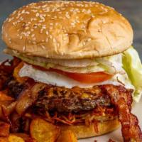 The Breakfast Burger · Topped with crispy hash browns, an egg cooked to order, cheddar cheese, bacon, lettuce, toma...