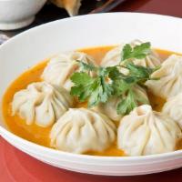 Jhol Momo (6Pc)  · Dumplings are dipped in our delicious gravy sauce with a homemade curry.
