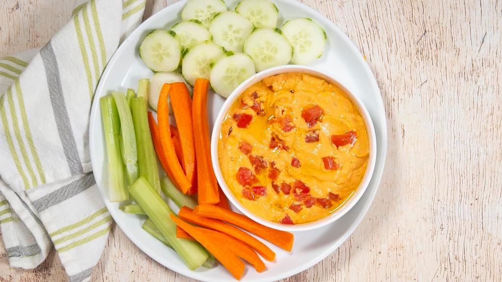 Hummus · Plain or roasted red pepper hummus. Served with carrots, cucumbers, and celery.