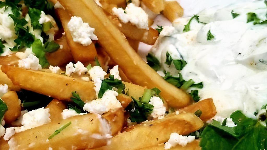 Greek Fries · Same cut size as French fries with a  homemade specialty garlic seasoning made with fresh garlic cloves and spices. 
The fries  are topped off with freshly chopped parsley, feta cheese and includes a side of homemade Tzatziki dip.