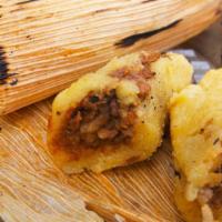Beef Tamales Meal · 2 of our thin crepe tamales Meño's style topped with our enchilada sauce, cotija cheese and ...