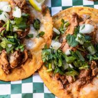 Queso Birria Taco · A taco on 2 corn tortillas with melted jack cheese topped with juicy beef Birria, onions, an...
