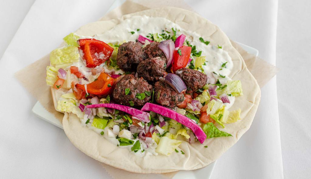 Beef Kafta Wrap · Ground top sirloin mixed with parsley, onions, and spices. Made with tzatziki. Each wrap is loaded with lettuce, onions, tomatoes, pickled turnips, and parsley.