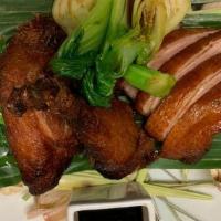 Honey Duck · Half duck marinated in soy and honey for 24 hours served with kailan and bok choi.