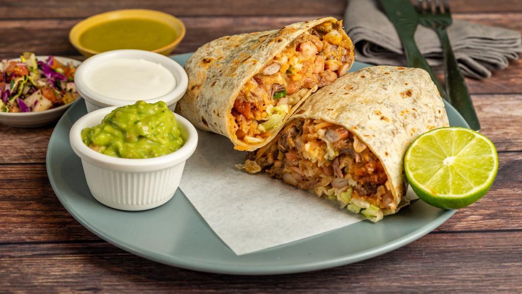 Tata Burrito · Rice, pinto beans, veggies or meat, pico de gallo, cheese, sour cream, guacamole lettuce, and salsa.