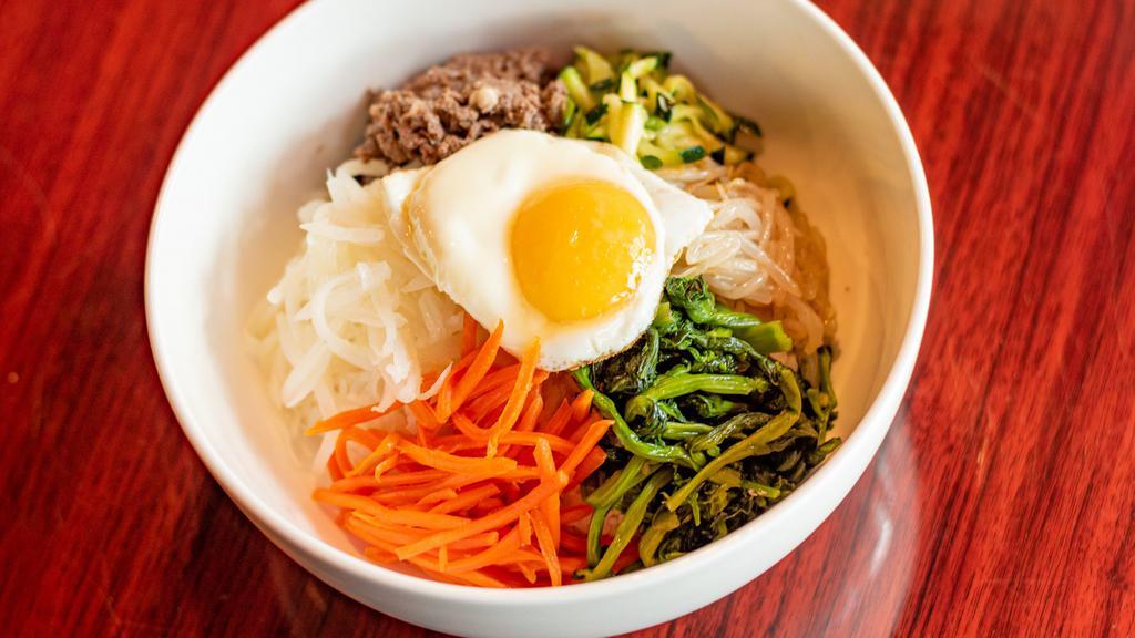 Bibimbap · Choice of vegetables, tofu or beef. Steamed white rice topped with variety assorted vegetables. Comes with an egg. (red pepper paste on side).