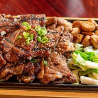 Galbi · Grilled short ribs marinated with a rich combination of soy sauce and vegetables.