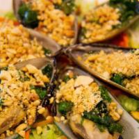Grilled Green Mussels · Topped with onions, peanuts, and lime. Gluten-free
