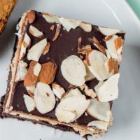 Mocha Almond Fudge Brownie · Fudge brownie topped with mocha buttercream, chocolate ganache & toasted almonds *contains a...