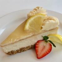 Slice Of Lemon Cheesecake · Lemon cheesecake w/ graham cracker crust & topped with lemon curd *contains coconut & soy
