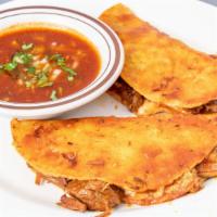 Quesabirria · Two corn tortillas grilled with red non- spicy salsa filled with shredded beef and cheese. S...
